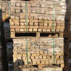 Two stacked pallets of reclaimed London yellow bricks from the side