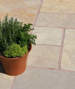 Plant pot on top of yellow limestone laid in outdoor patio