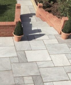Kandla grey sandstone patio with stairs leading to path surrounded by brick wall