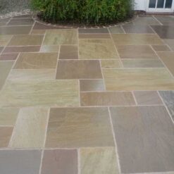 Mixed sizes of Raj green sandstone laid in outdoor patio area