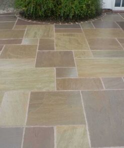 Mixed sizes of Raj green sandstone laid in outdoor patio area